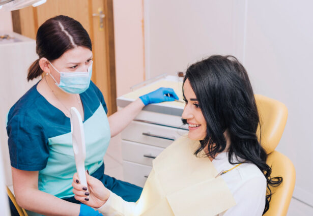 happy patient looking at the mirror